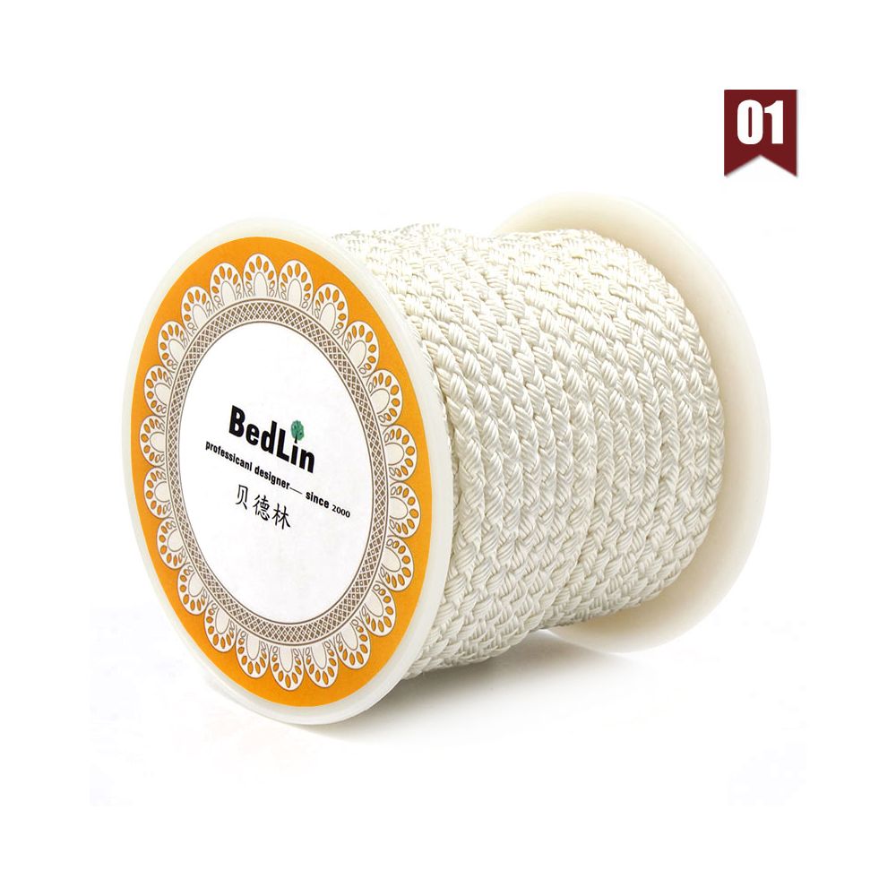 Spool of white thread with an orange label on a white background